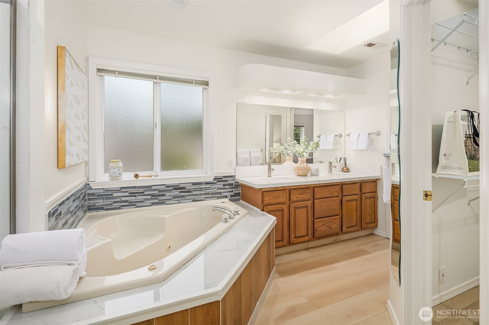 1417 232nd Place Southwest Bothell, WA 98021 - Photo 25 of 40 a bathroom with a tub sink and mirror