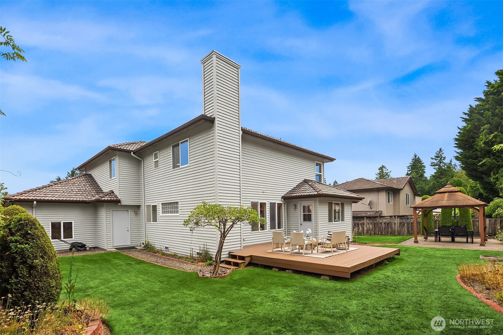 1417 232nd Place Southwest Bothell, WA 98021 - Photo 30 of 40 a front view of house with a garden and patio