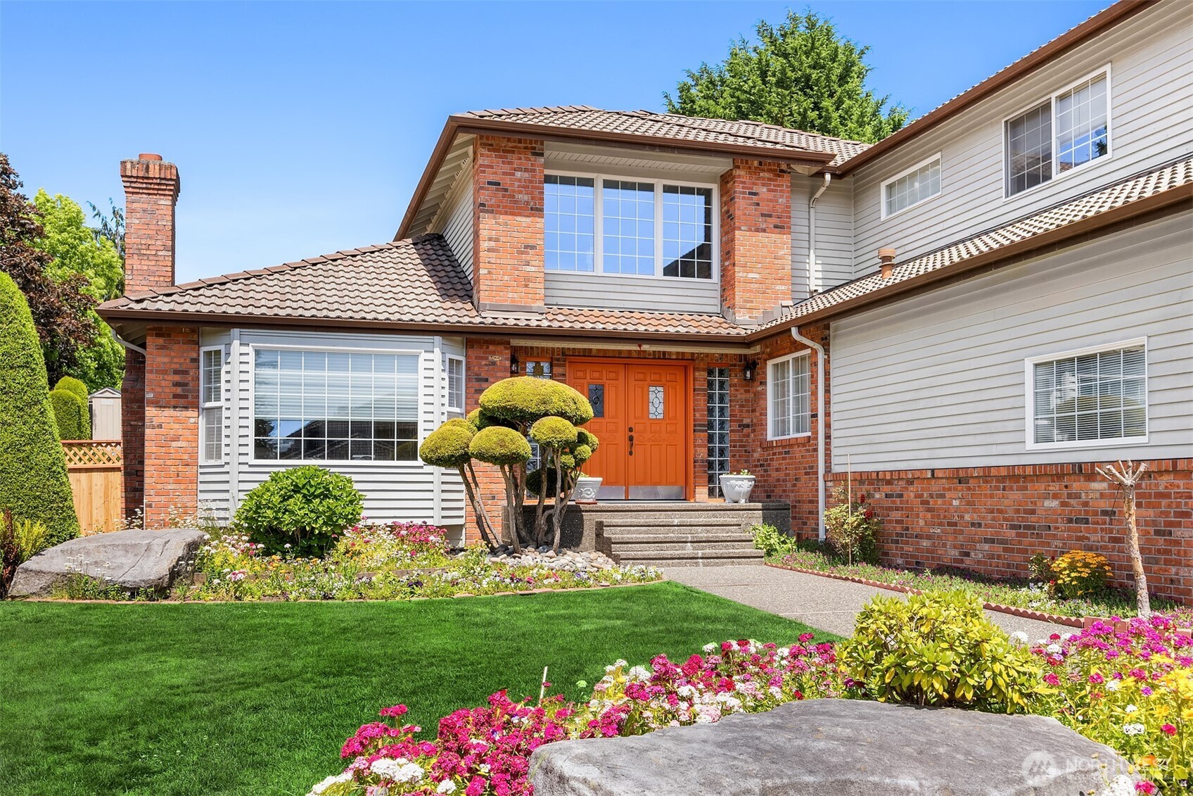 1417 232nd Place Southwest Bothell, WA 98021 - Photo 3 of 40 a front view of a house with a yard
