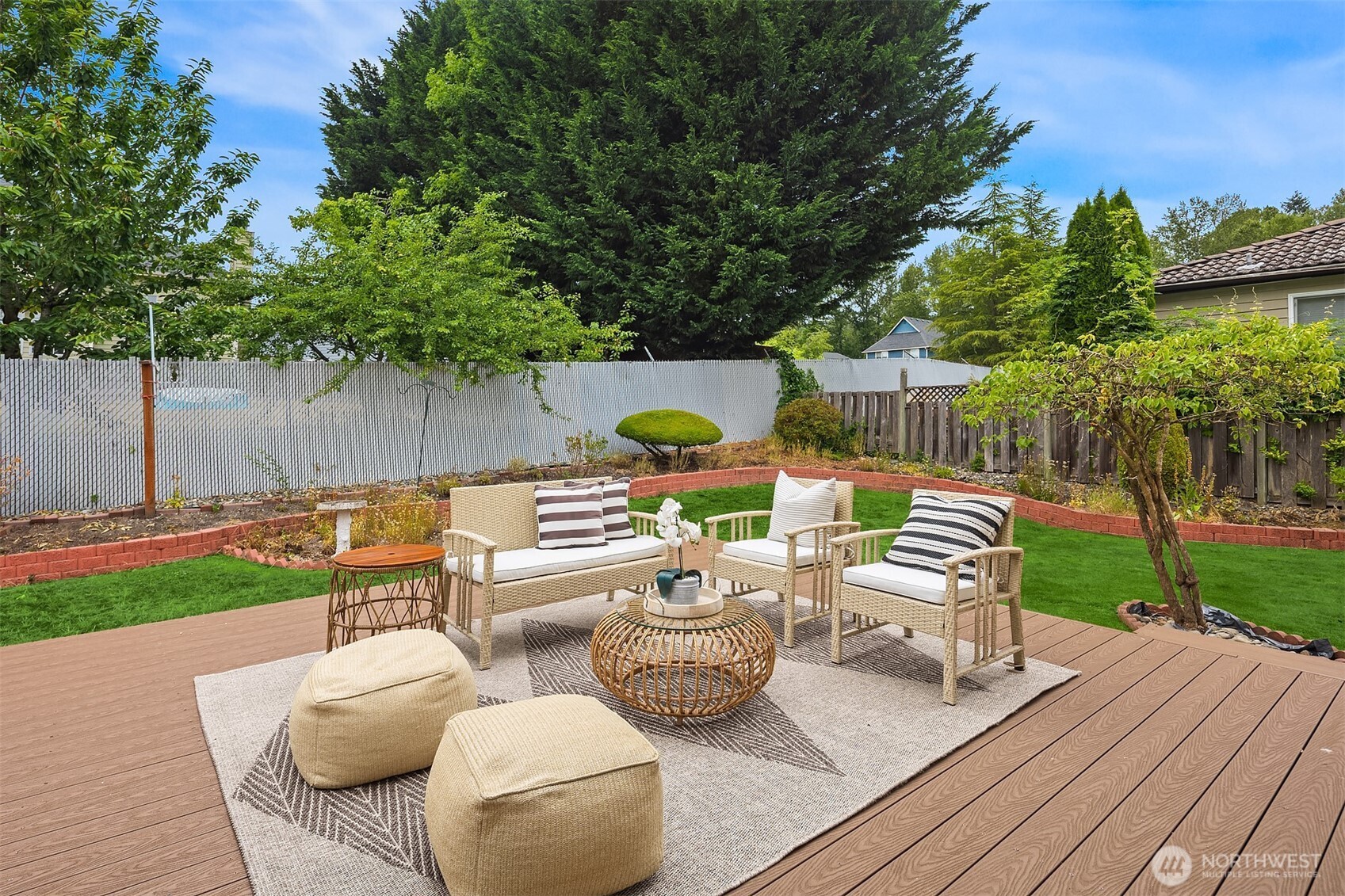 1417 232nd Place Southwest Bothell, WA 98021 - Photo 32 of 40 a view of a patio with couches chairs and a table and chairs with wooden fence