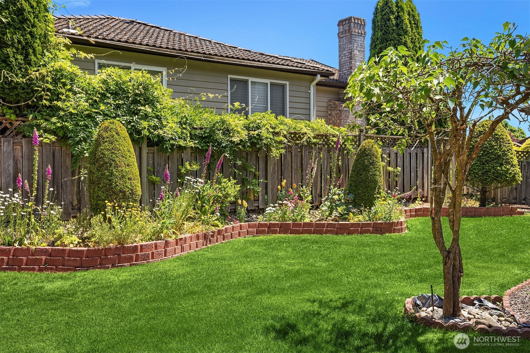 1417 232nd Place Southwest Bothell, WA 98021 - Photo 36 of 40 a front view of a house with a garden