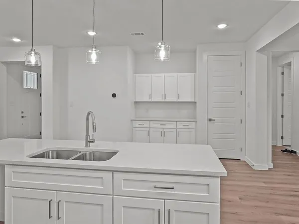 a kitchen with a sink and cabinets