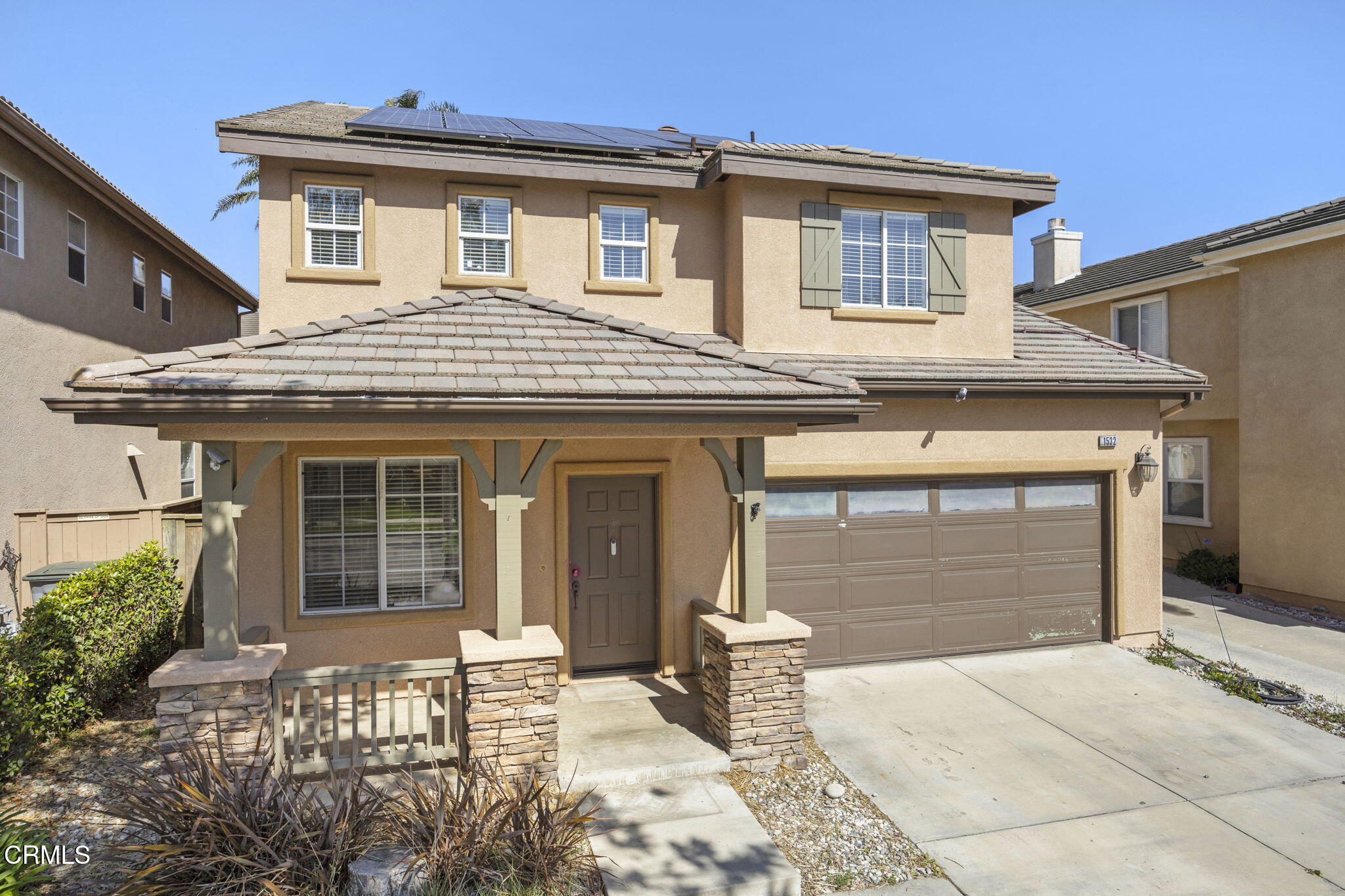 1532 Sonata Drive Oxnard, CA 93030 - Photo 2 of 2 a front view of a house with a garden