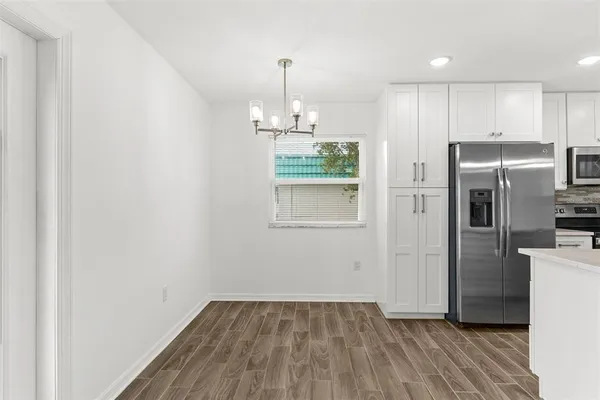 a view of a kitchen with a sink and refrigerator