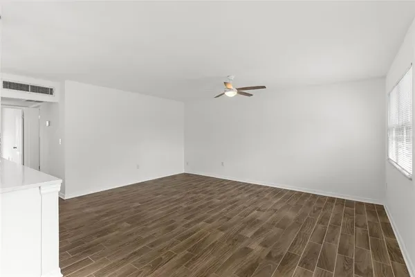 a view of a room with wooden floor