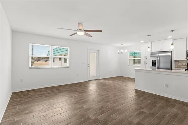 a view of a kitchen with microwave and wooden floor