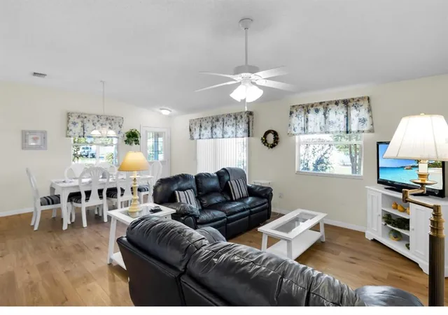a living room with furniture a window and a chandelier