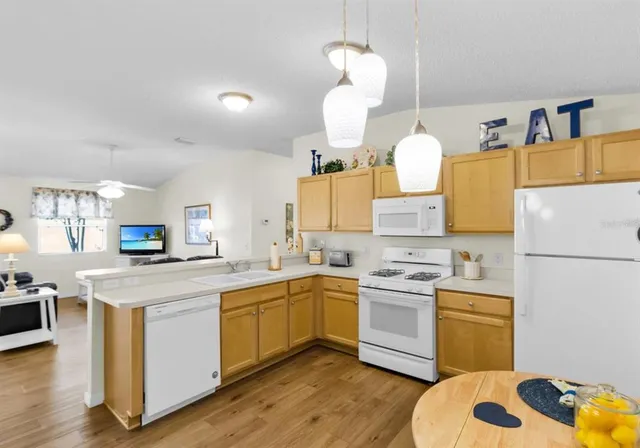 a kitchen with a sink a stove and refrigerator