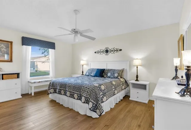 a bedroom with a bed chandelier and a window