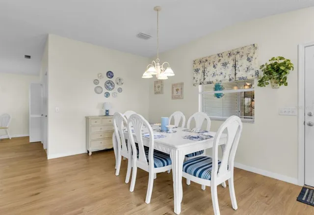 a view of a dining room with furniture and chandelier
