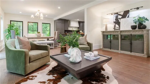 a living room with furniture potted plant and windows