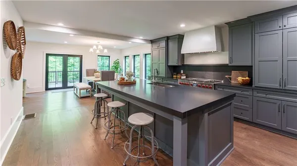 a open kitchen with stainless steel appliances granite countertop a sink stove and refrigerator