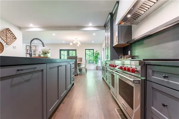 a kitchen with kitchen island a stove and a sink