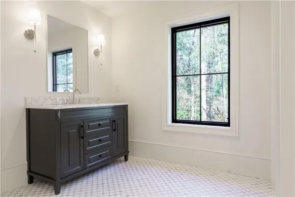 a bathroom with a sink vanity and a mirror
