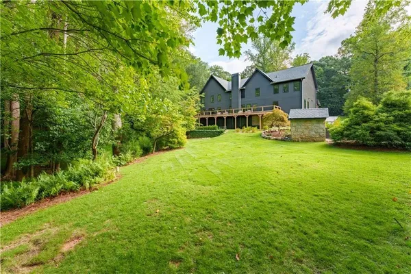 a front view of a house with yard and green space