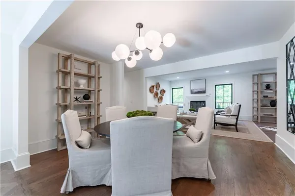a living room with furniture a bookshelf and a chandelier