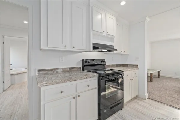 a living room with furniture and kitchen view