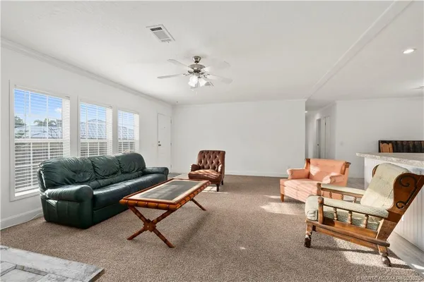 a room with pool table and windows