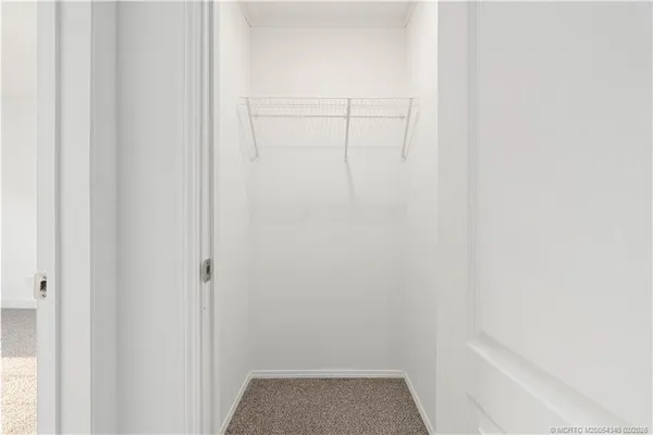 a view of a house with outdoor space and a parking area