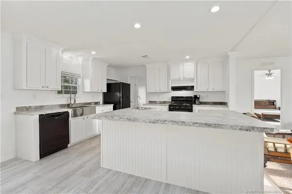 a living room with furniture a dining table and kitchen view