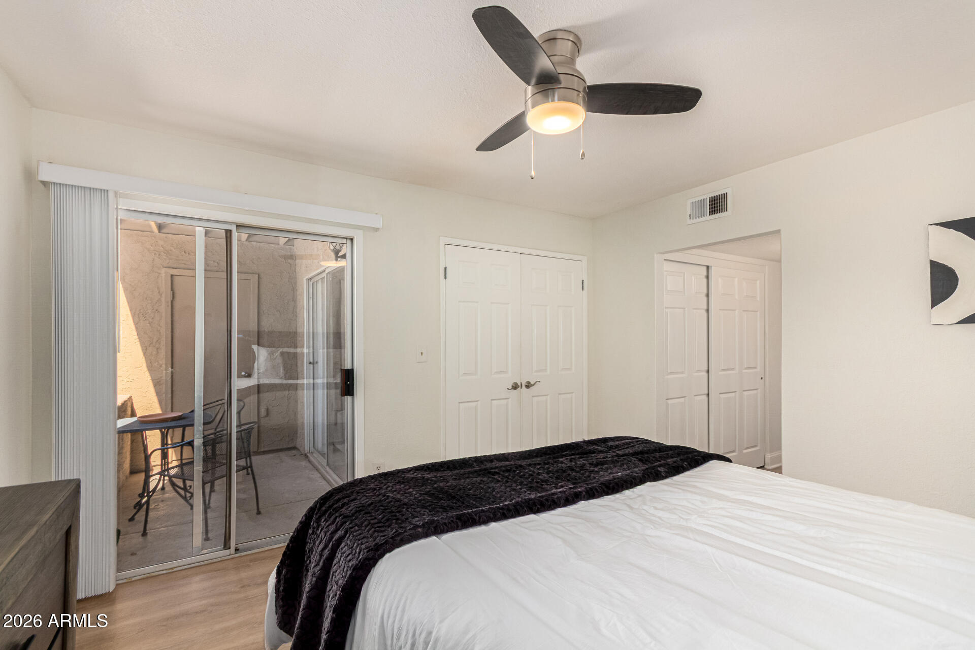5877 North Granite Reef Road, Unit 1133 Scottsdale, AZ 85250 - Photo 19 of 33 a bedroom with a bed and a chandelier