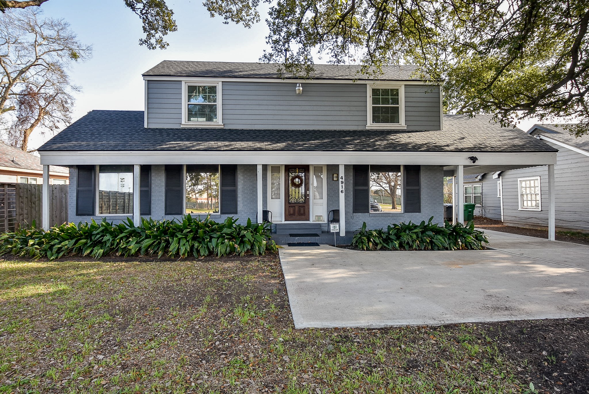a front view of brick house with yard and green space