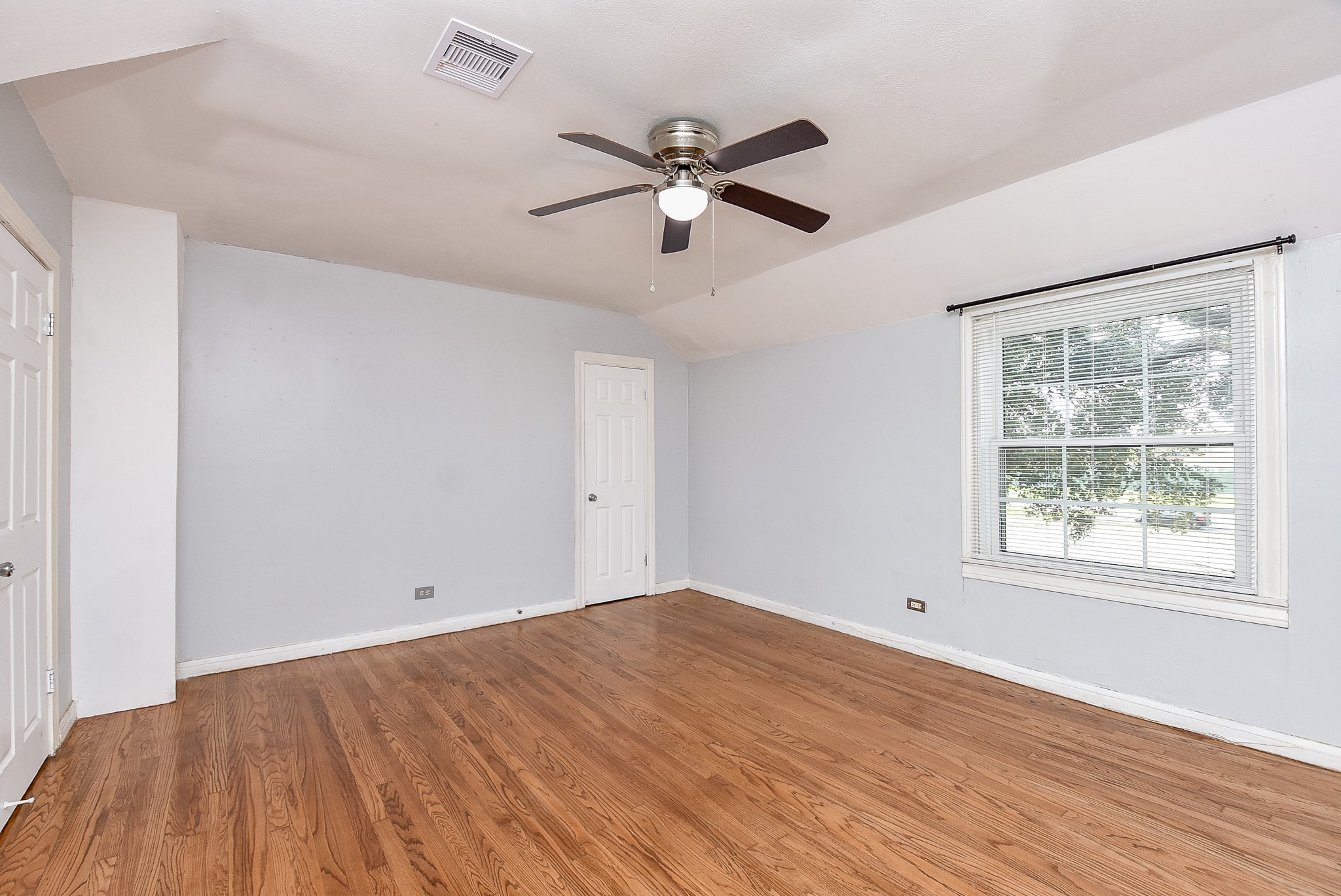 4916 Old Spanish Trail Houston, TX 77021 - Photo 19 of 32 a view of empty room with wooden floor and fan