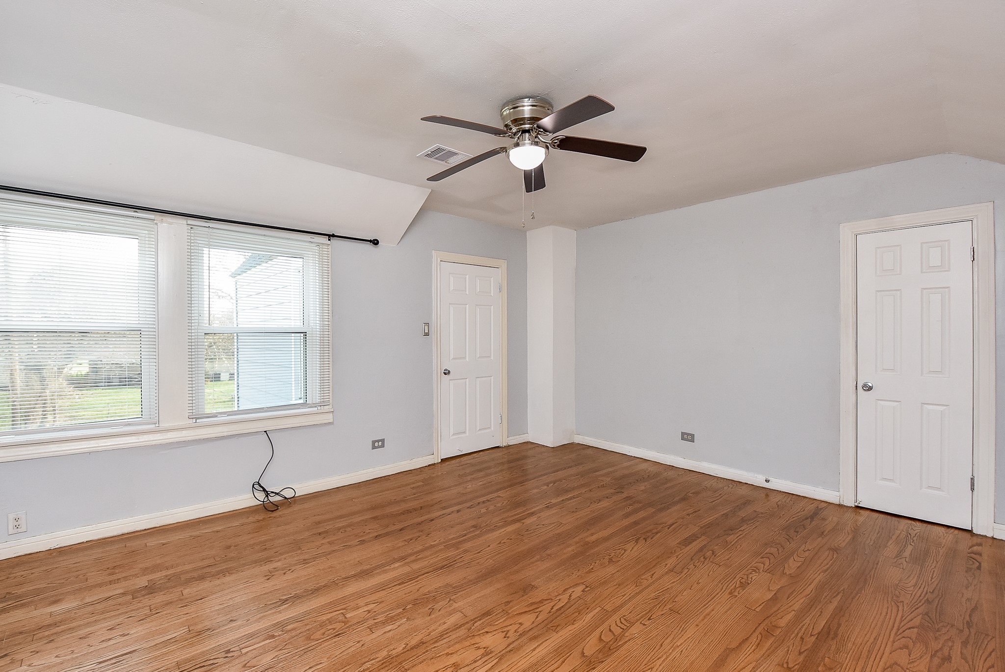 4916 Old Spanish Trail Houston, TX 77021 - Photo 20 of 32 a view of empty room with wooden floor and fan