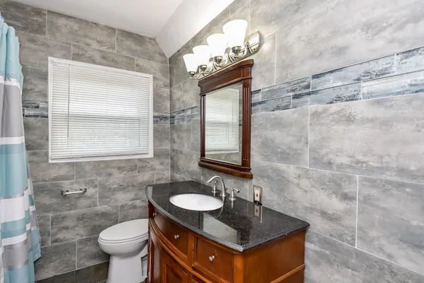a bathroom with a sink a mirror and shower