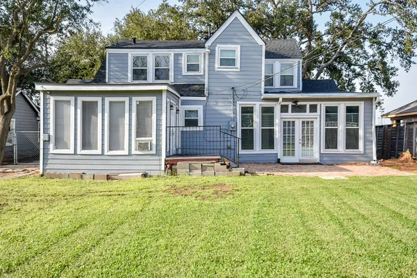 a front view of a house with swimming pool and porch