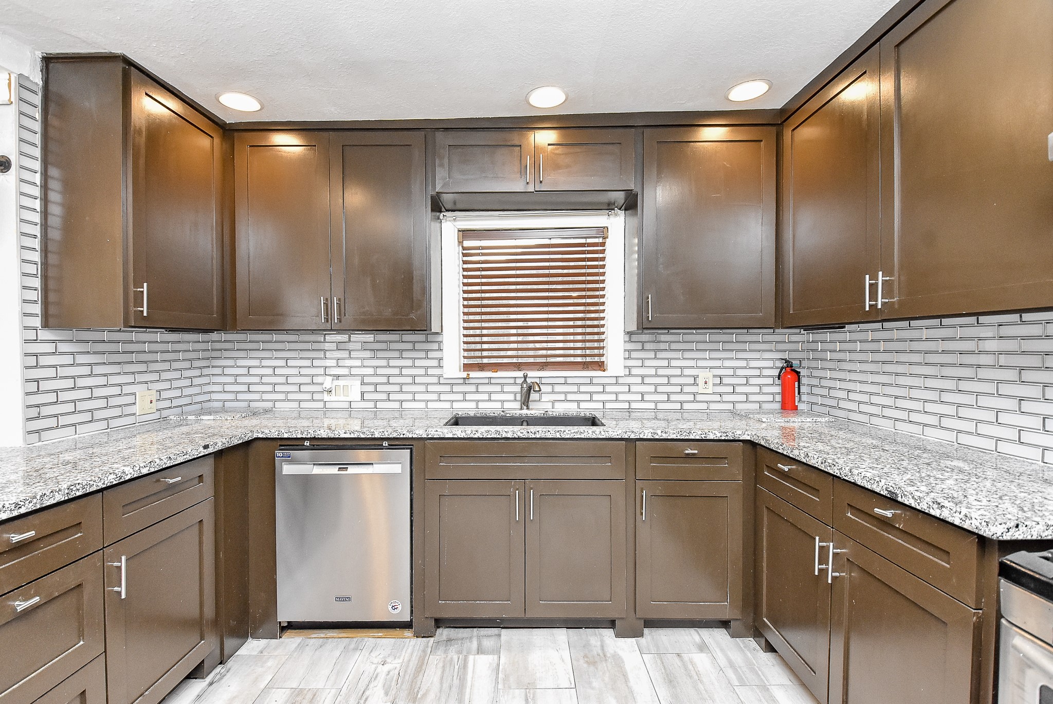 4916 Old Spanish Trail Houston, TX 77021 - Photo 8 of 32 a kitchen with a sink dishwasher a stove and cabinets