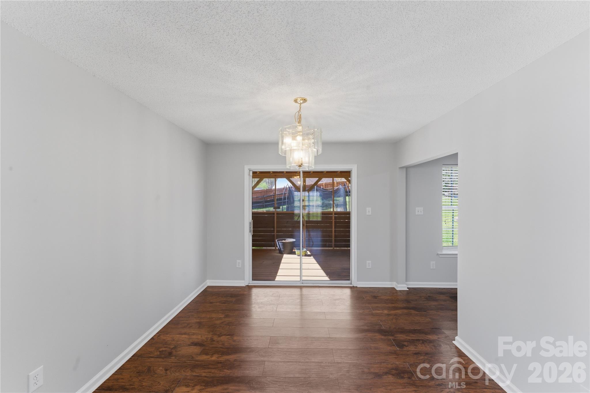8608 Moody Road Charlotte, NC 28215 - Photo 11 of 33 an empty room with wooden floor and windows
