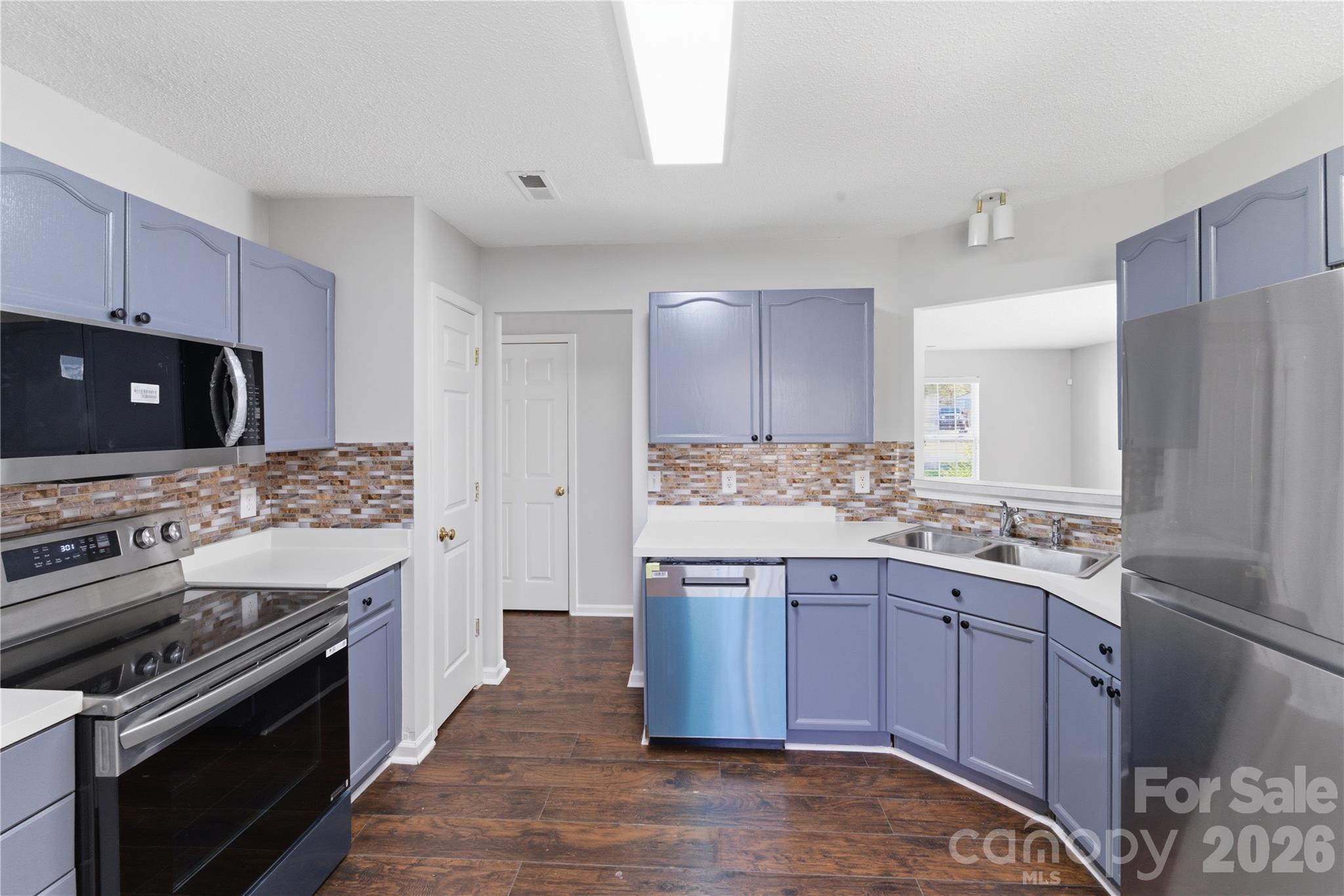 8608 Moody Road Charlotte, NC 28215 - Photo 12 of 33 a kitchen with a stove and a microwave
