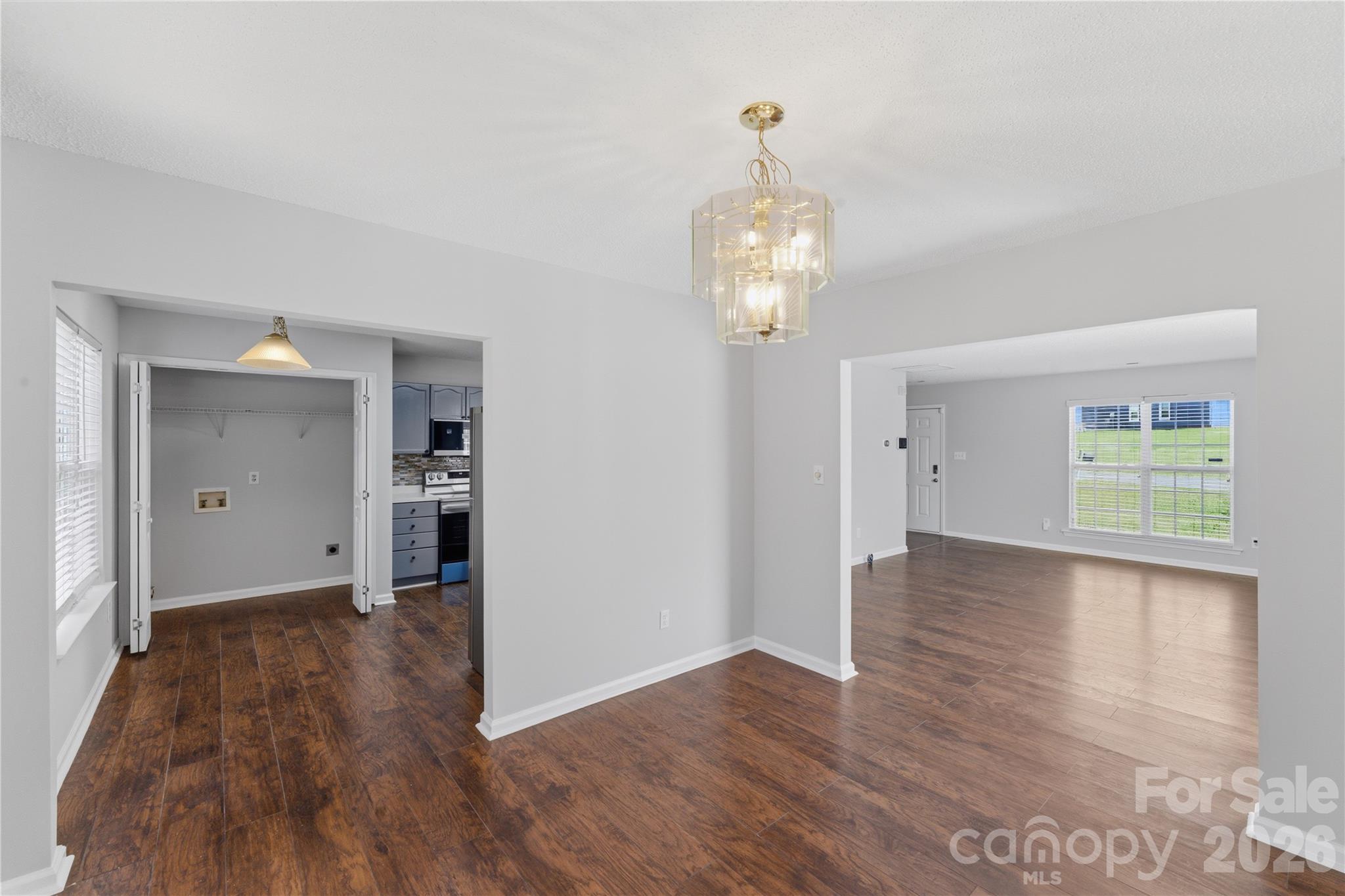 8608 Moody Road Charlotte, NC 28215 - Photo 13 of 33 a view of livingroom with hardwood floor and kitchen view