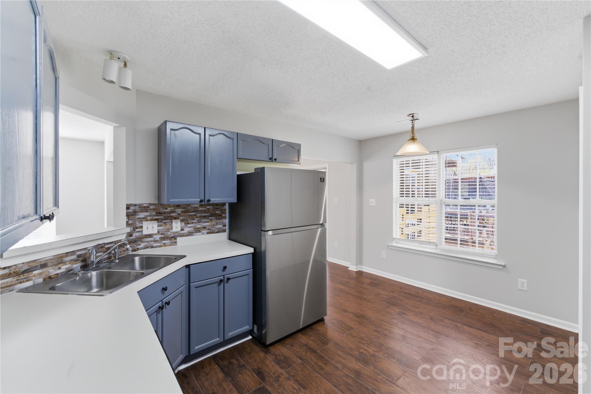 8608 Moody Road Charlotte, NC 28215 - Photo 14 of 33 a kitchen with stainless steel appliances granite countertop a refrigerator and a sink