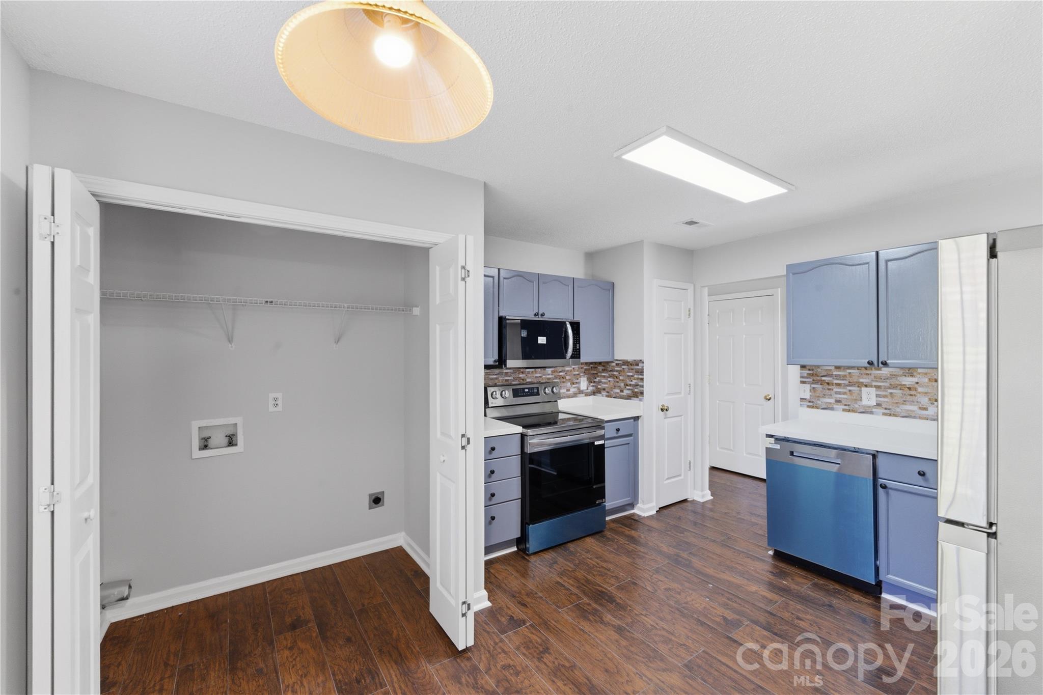 8608 Moody Road Charlotte, NC 28215 - Photo 15 of 33 a kitchen with a sink and a stove top oven
