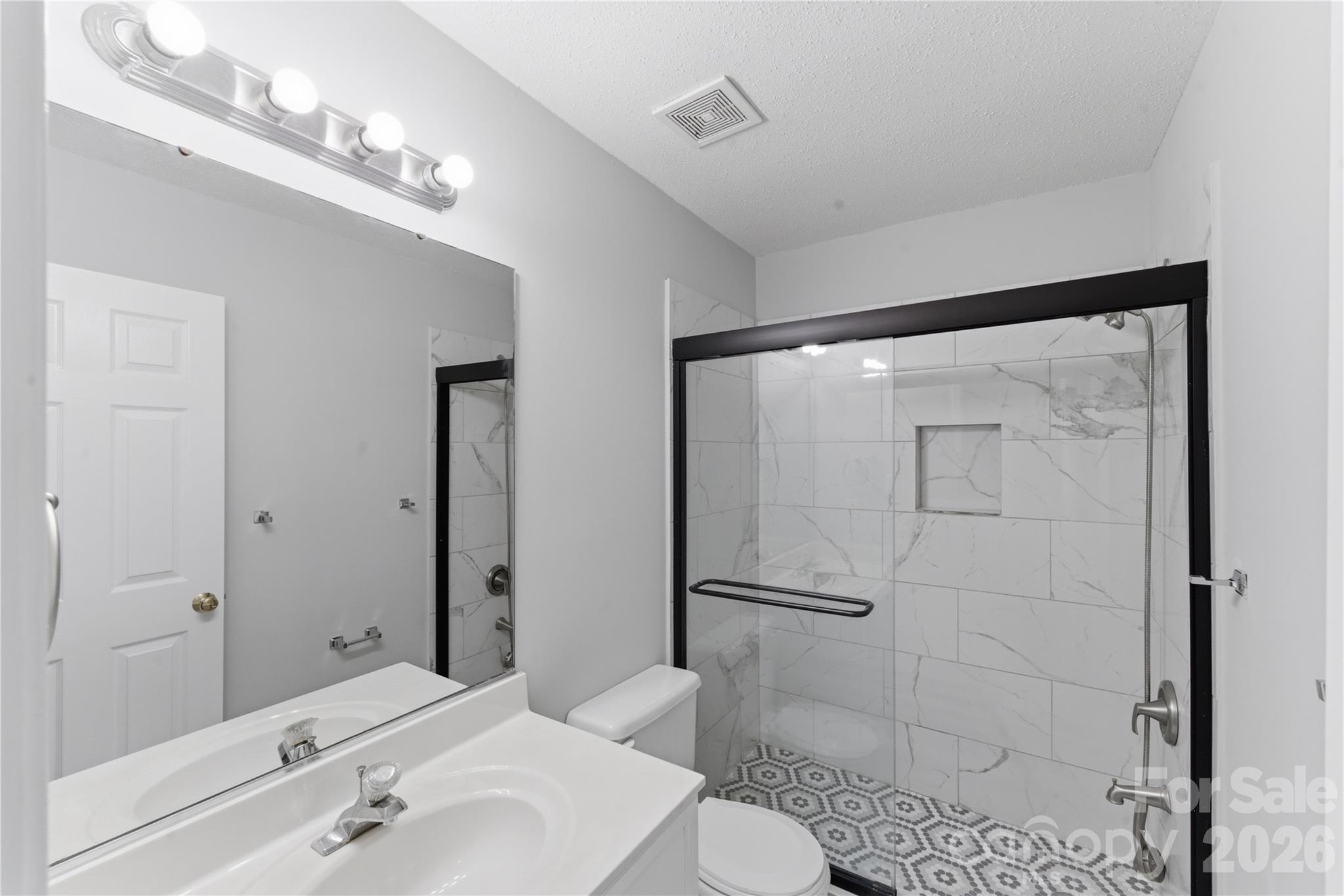 8608 Moody Road Charlotte, NC 28215 - Photo 17 of 33 a bathroom with a sink a toilet and shower