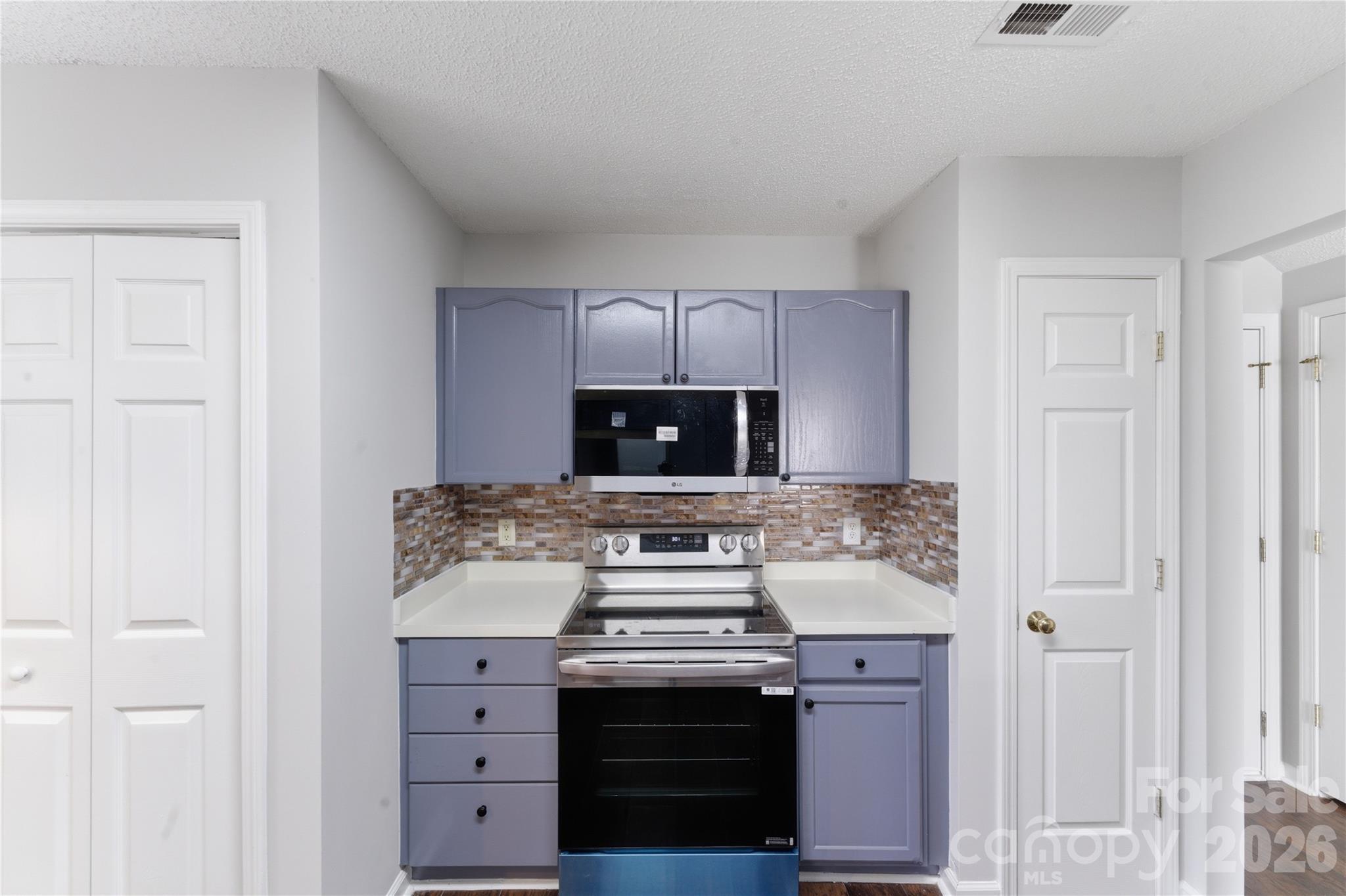 8608 Moody Road Charlotte, NC 28215 - Photo 18 of 33 a stove top oven sitting inside of a kitchen
