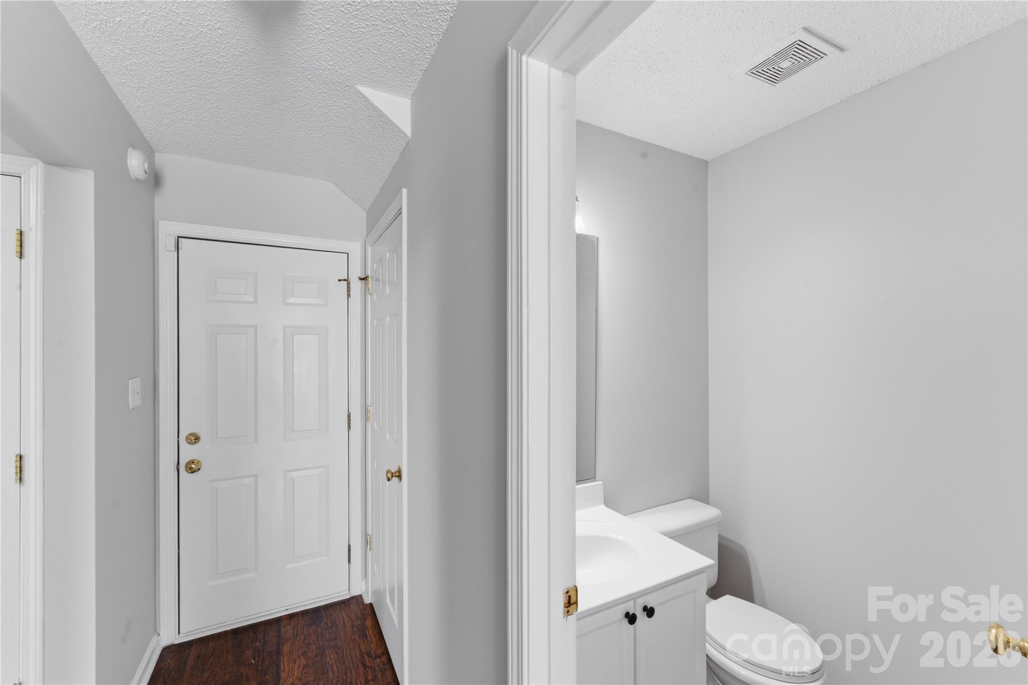 8608 Moody Road Charlotte, NC 28215 - Photo 19 of 33 a bathroom with a sink toilet and vanity