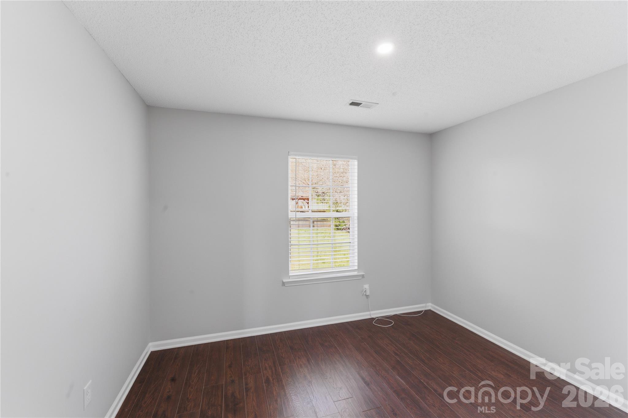 8608 Moody Road Charlotte, NC 28215 - Photo 20 of 33 wooden floor in an empty room with a window