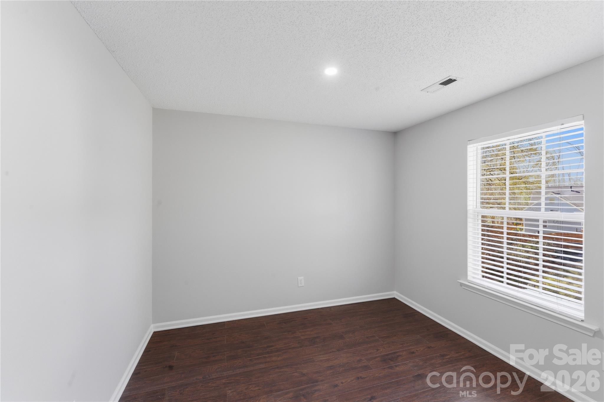 8608 Moody Road Charlotte, NC 28215 - Photo 21 of 33 a view of an empty room with wooden floor and a window