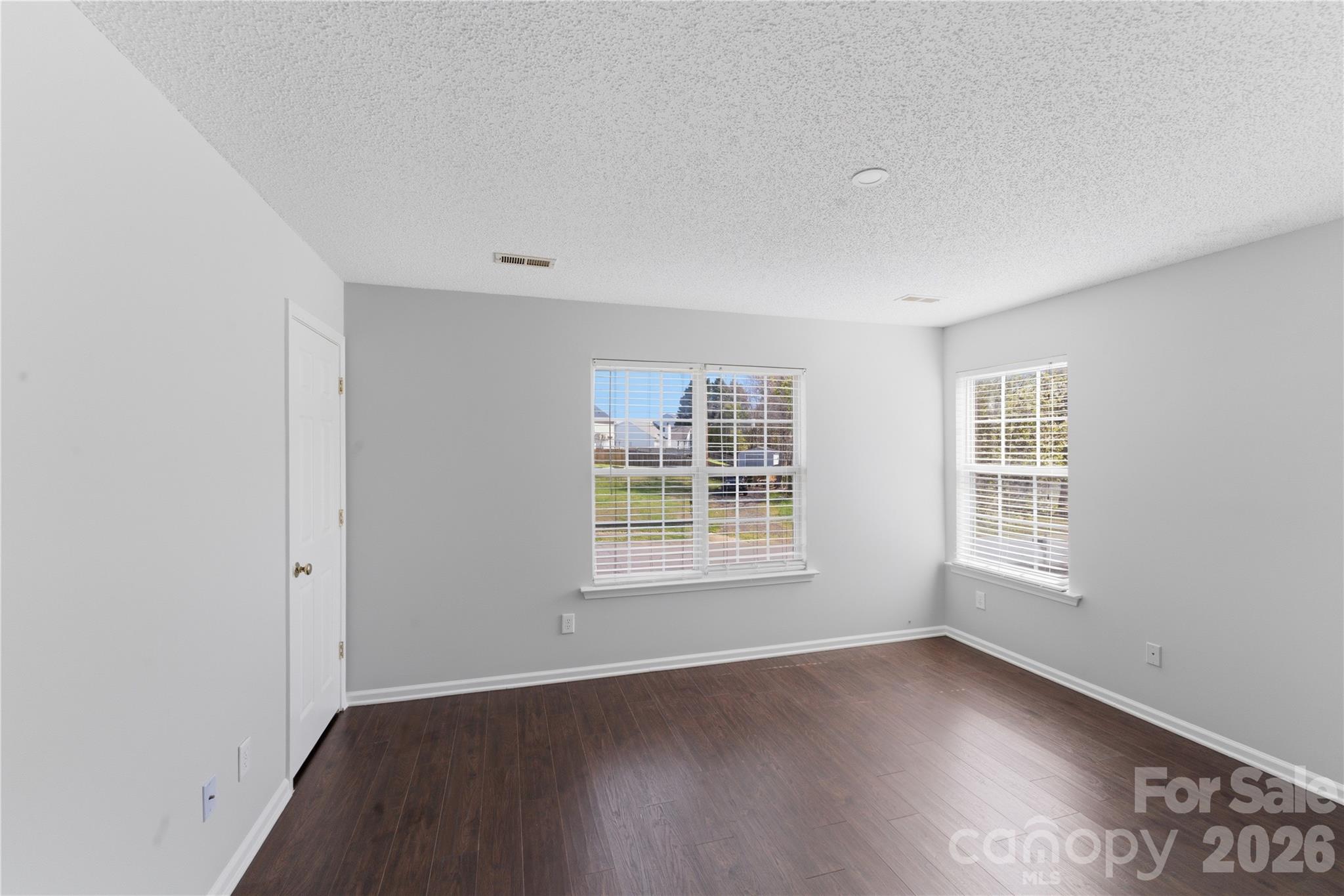 8608 Moody Road Charlotte, NC 28215 - Photo 22 of 33 an empty room with wooden floor and windows