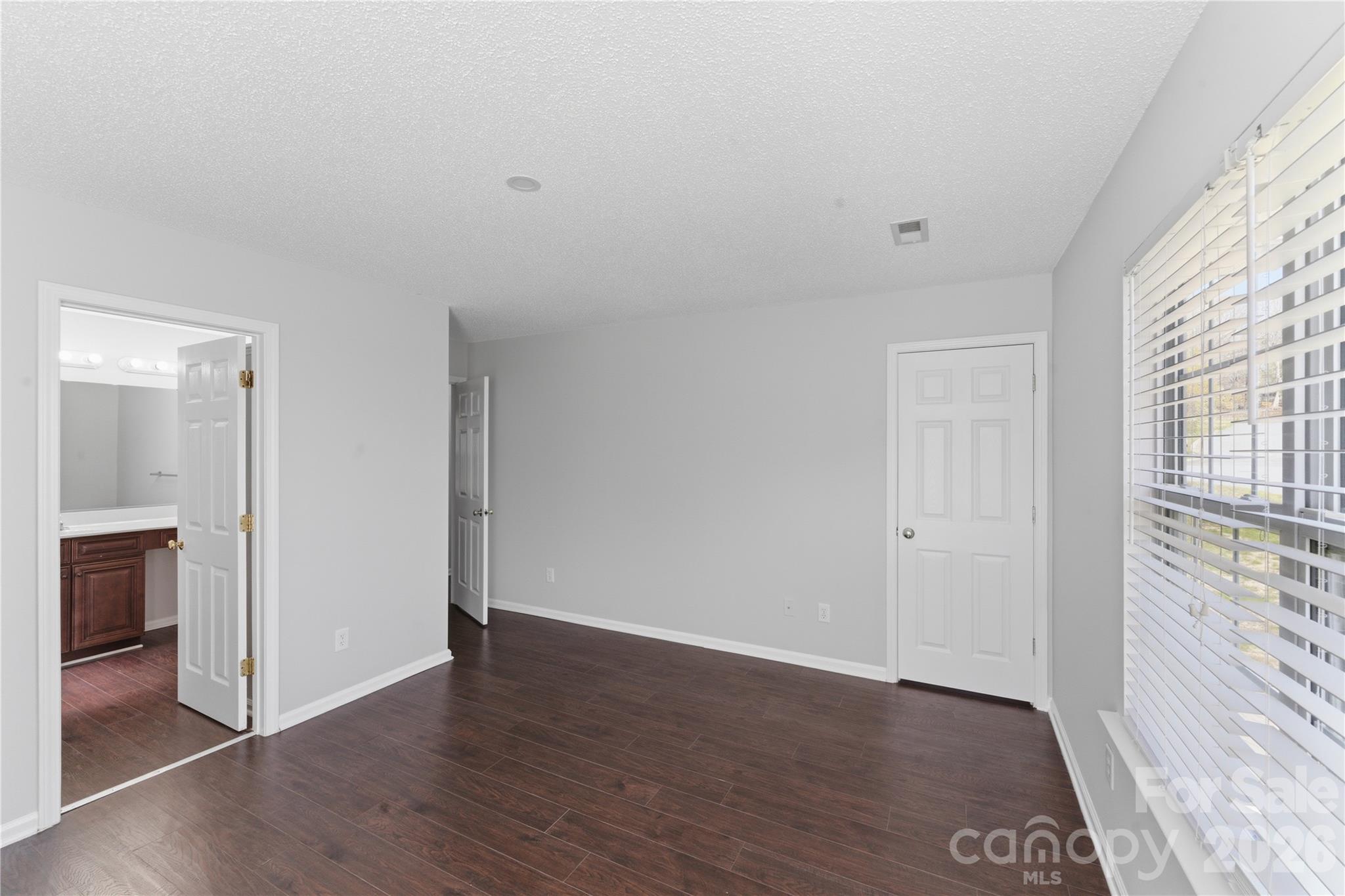 8608 Moody Road Charlotte, NC 28215 - Photo 23 of 33 a view of an empty room with wooden floor and a window