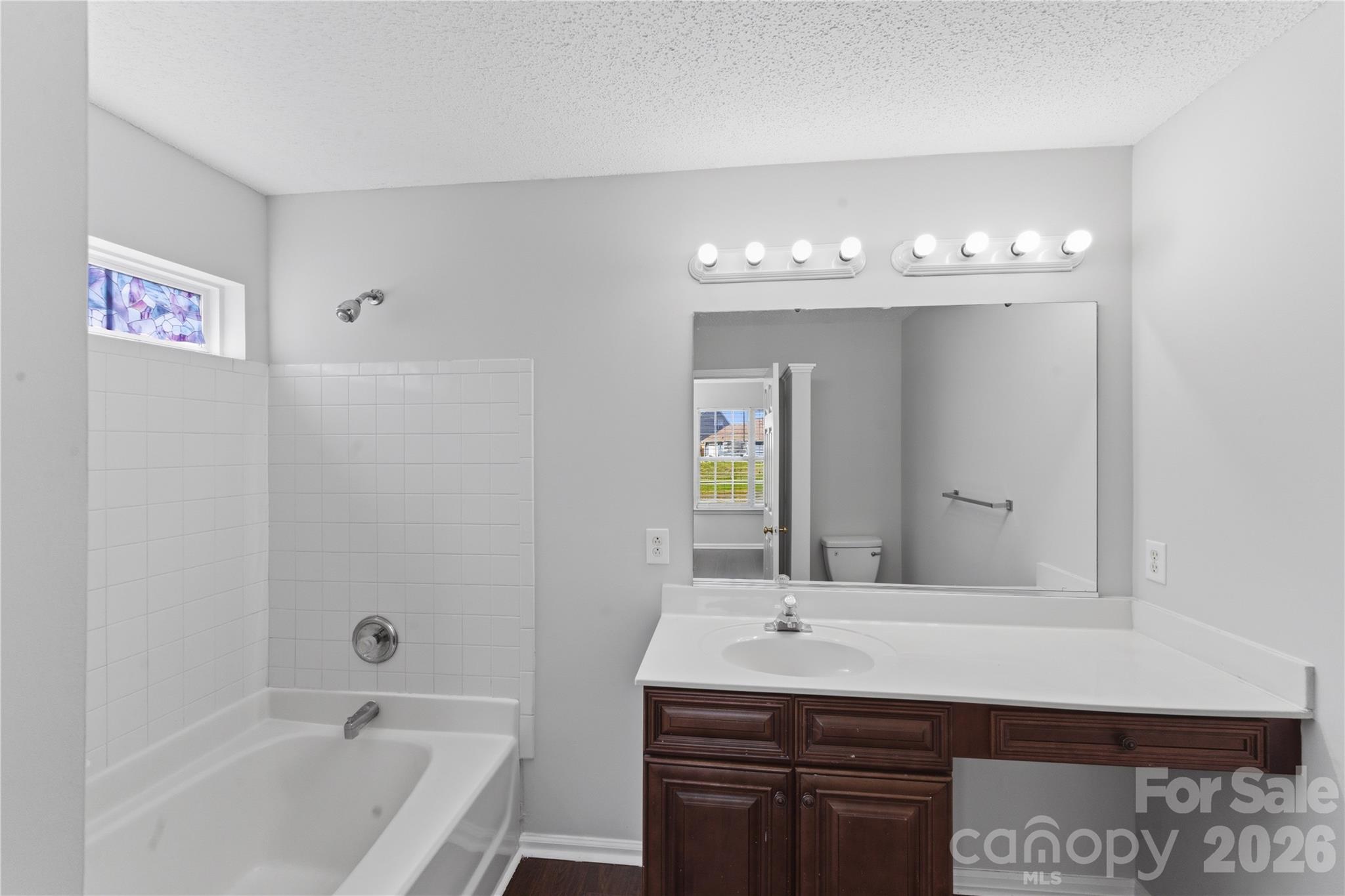 8608 Moody Road Charlotte, NC 28215 - Photo 25 of 33 a bathroom with a sink a large mirror and a bathtub