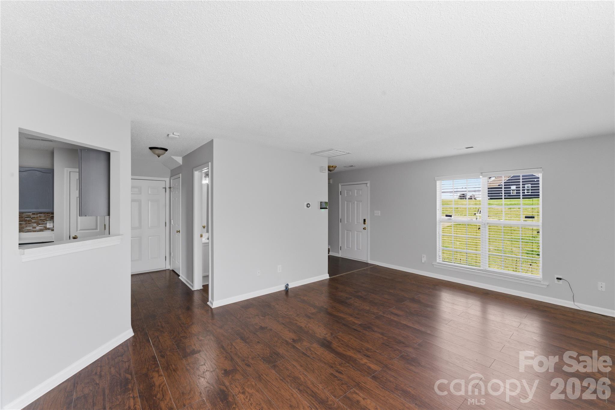 8608 Moody Road Charlotte, NC 28215 - Photo 4 of 33 an empty room with wooden floor and windows