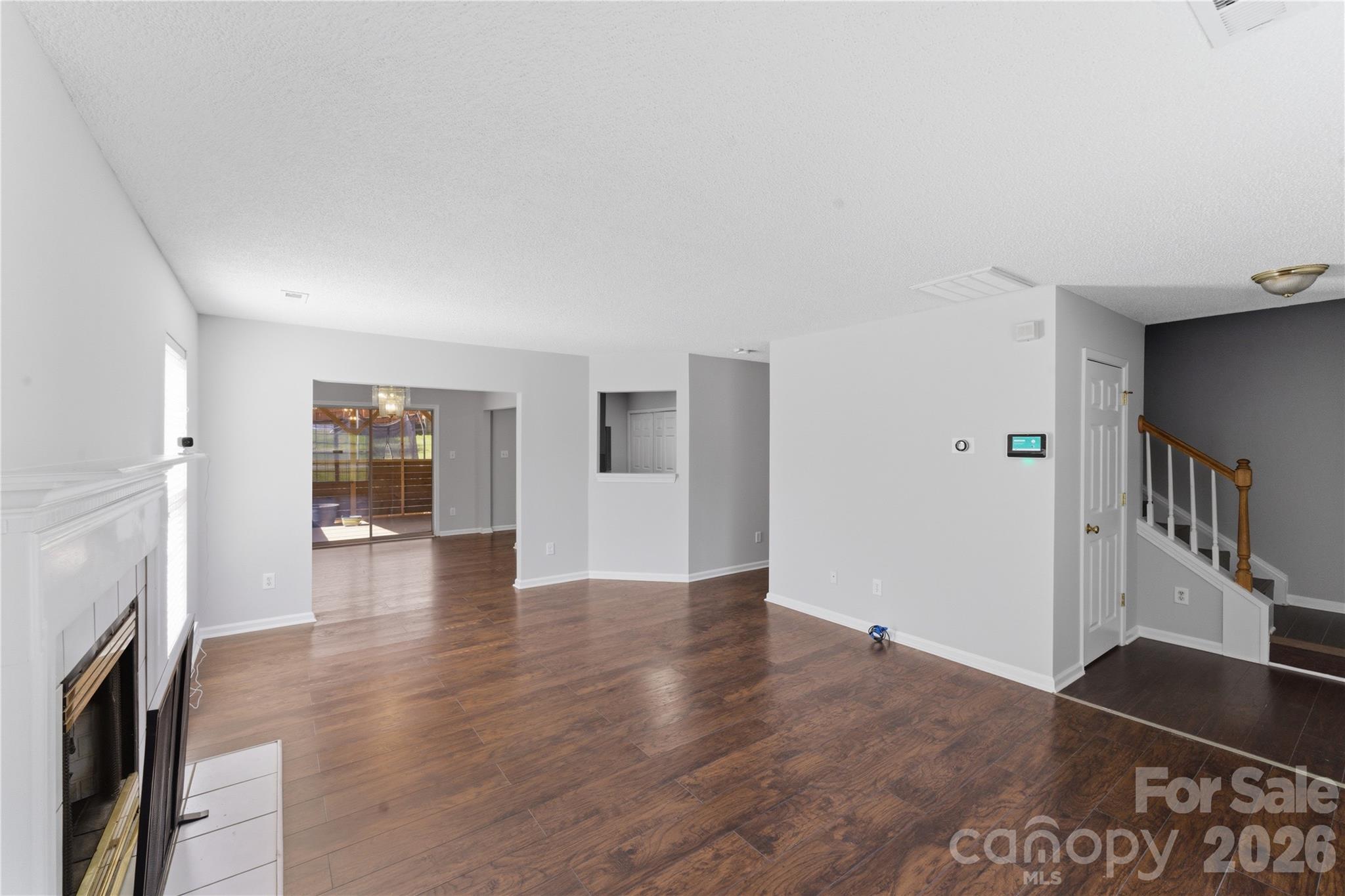 8608 Moody Road Charlotte, NC 28215 - Photo 9 of 33 a view of empty room with wooden floor and fireplace