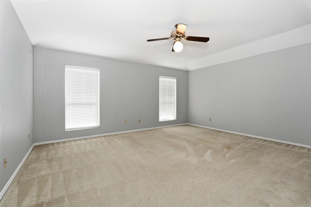 7205 Windcrest Court East North Richland Hills, TX 76182 - Photo 17 of 35 an empty room with windows and fan
