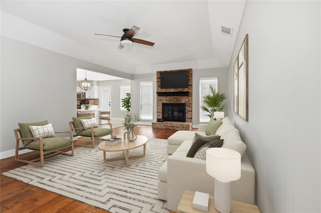 7205 Windcrest Court East North Richland Hills, TX 76182 - Photo 2 of 35 a living room with furniture a fireplace and a flat screen tv