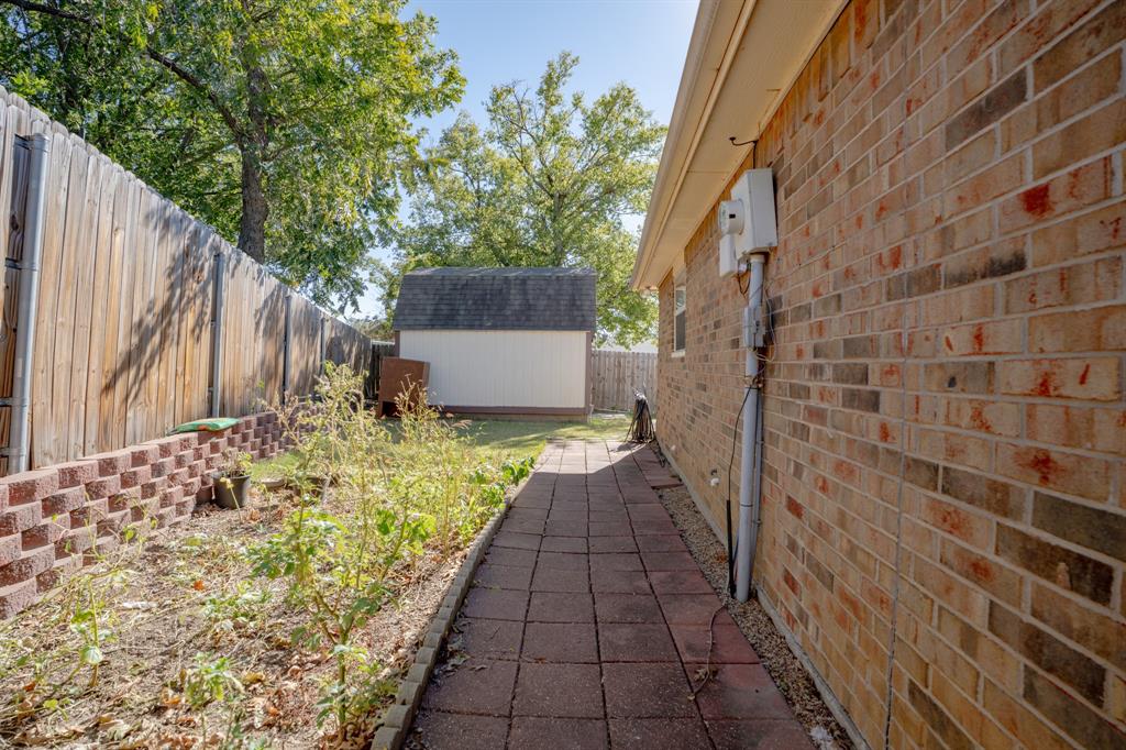 7205 Windcrest Court East North Richland Hills, TX 76182 - Photo 22 of 35 a view of a pathway both side of house