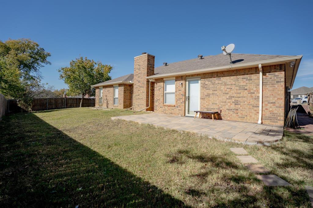 7205 Windcrest Court East North Richland Hills, TX 76182 - Photo 23 of 35 a view of a house with backyard and a yard